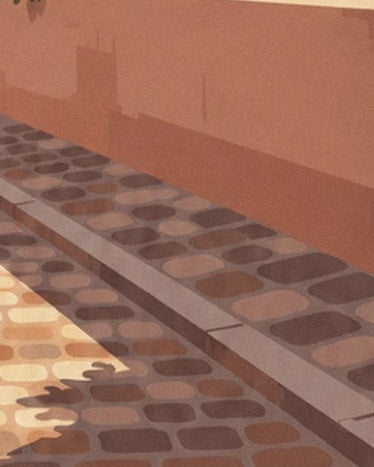 Les pavés aux tons ocre et bruns, bordés d'un trottoir au pied du mur rose