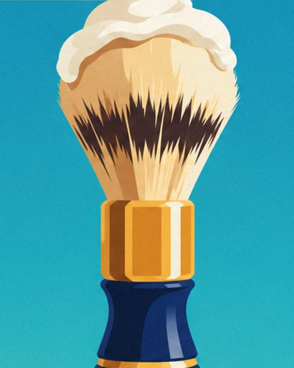 The foamy shaving brush with its navy blue handle and golden band, against a turquoise background