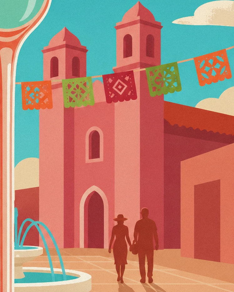 A couple holding hands in front of a pink church with two bell towers and colourful bunting