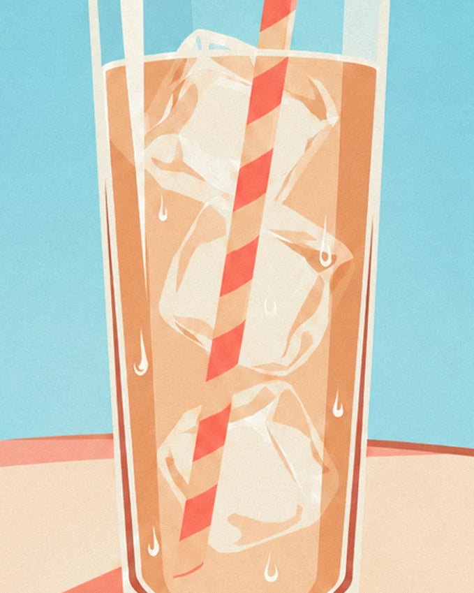 The tall glass of iced coffee, with ice cubes and a red and white striped straw