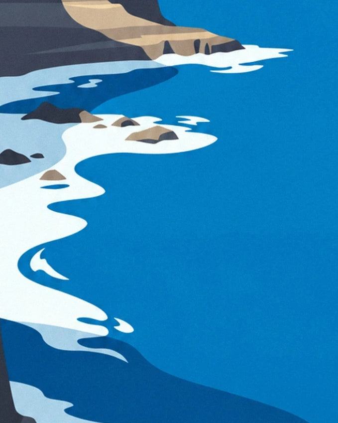 White foamy waves lapping at the rocks in a deep blue sea