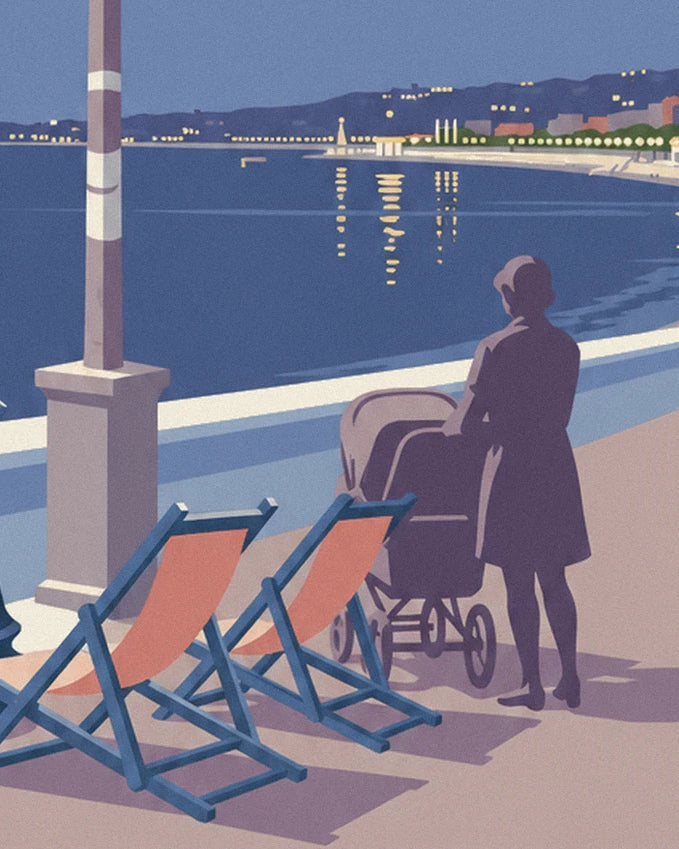 A woman walking with her pram near 2 orange deckchairs, facing the bay in the evening