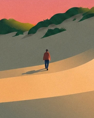 A walker in a red jacket at the foot of the shaded dunes of l’Espiguette