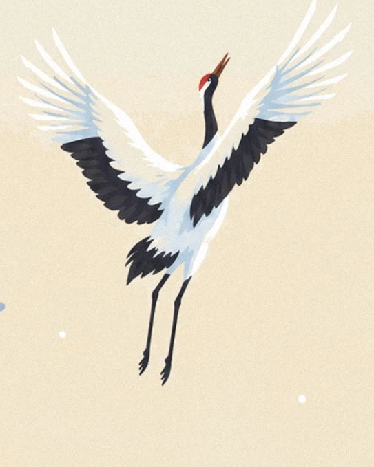 A red-crowned crane with its beak raised and black and white wings spread