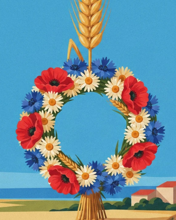 The wreath of poppies, daisies and cornflowers, tied to its sheaf of wheat