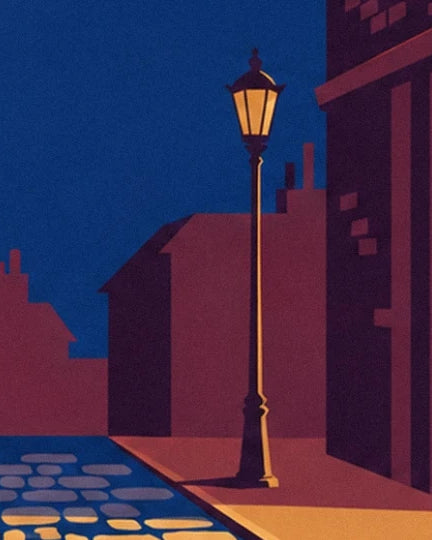 A street lamp casting amber light on the pavement between burgundy façades