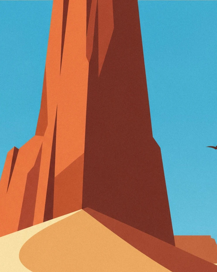 Le pilier de roche rouge dressé sous un ciel bleu, au-dessus de la dune dorée