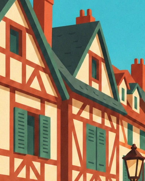 Les maisons à colombages rouges, volets verts et toits pentus sous le ciel bleu