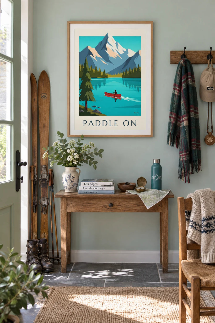 Poster of a canoe on an alpine lake and snow-capped mountains: framed on the wall