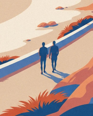 The 2 walkers with long shadows on the path bordered by a low blue wall