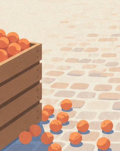 The orange fruit scattered on the cobbles at the foot of the wooden crates