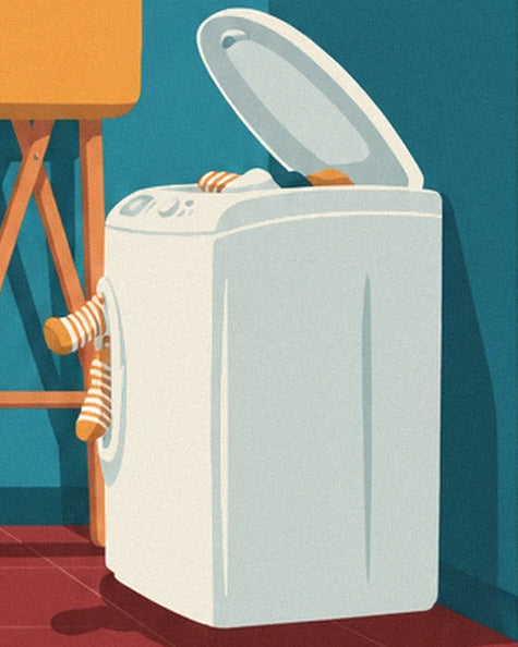 The white washing machine with its lid open and striped socks peeking out