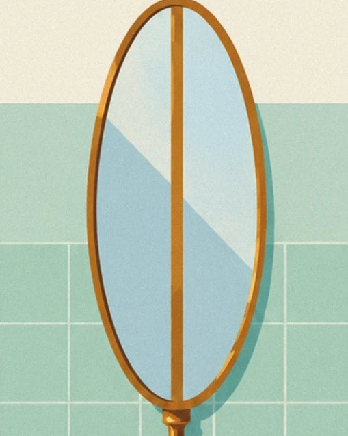 The oval mirror with a golden frame against the green bathroom tiles