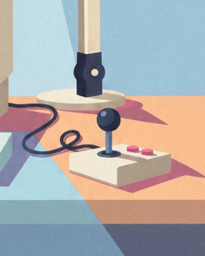 The joystick with its dark ball top, 2 pink buttons and looped cable on the desk