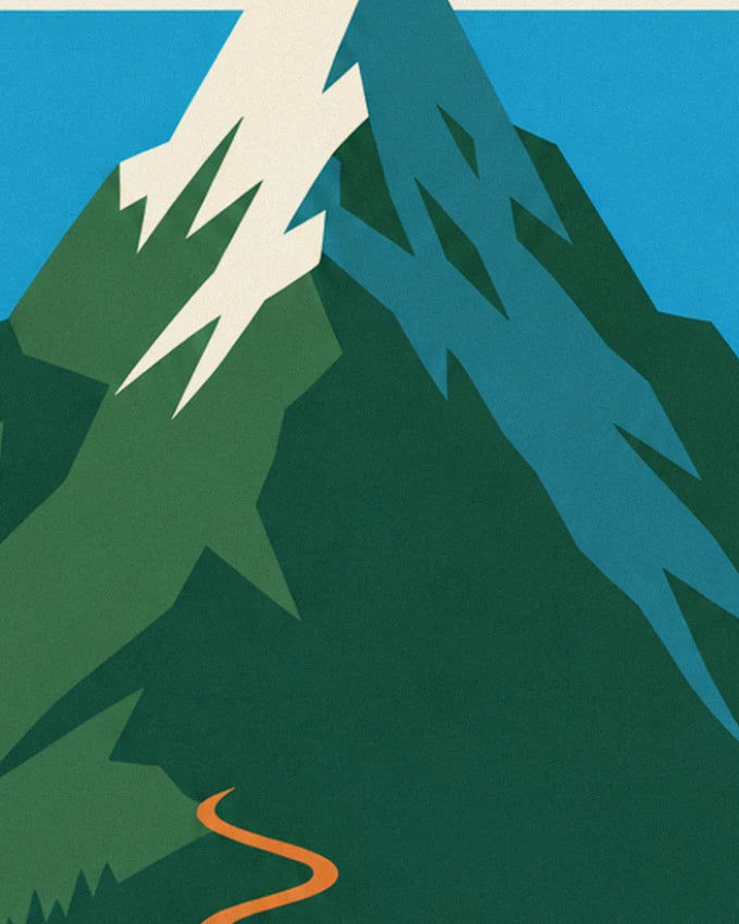 The snow-covered mountain peak beneath a blue sky, with the track winding below