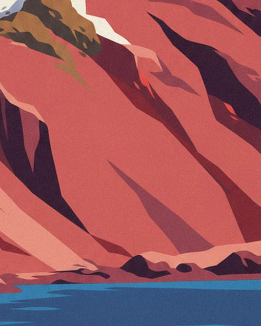 The red cliff with purple shadows and rocks beside the blue water