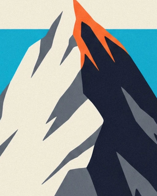 The snowy ridge edged in orange, between midnight blue shadows and a turquoise sky