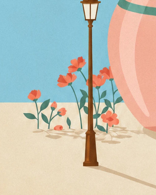 Le lampadaire en fer brun entouré de fleurs rouges, au pied du grand pot rose