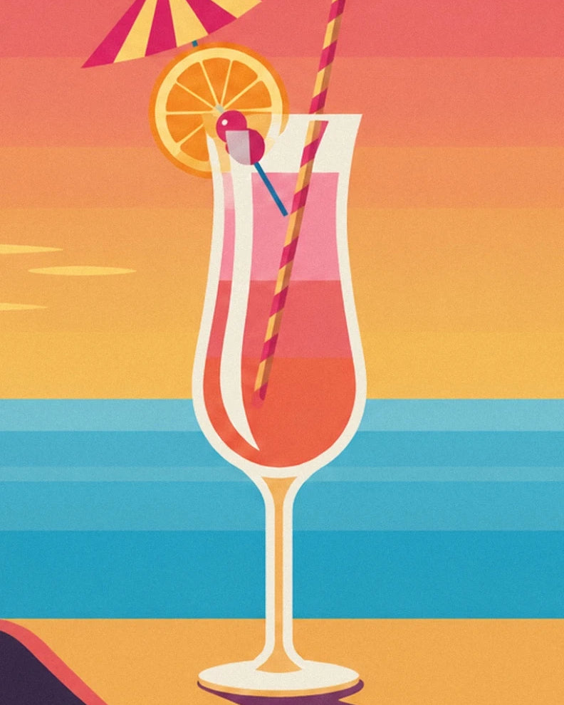 A pink-orange cocktail with an orange slice and striped straw overlooking the sea