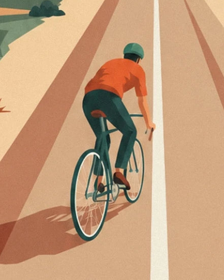 The cyclist in an orange jersey and green helmet on his road bike