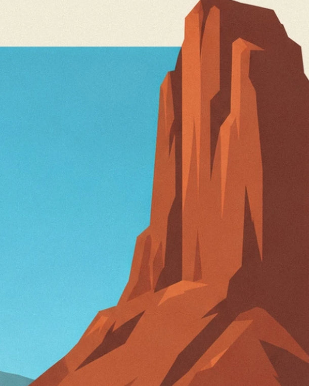 The orange-red rock face with angular shadows beneath a blue sky