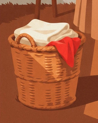 The woven basket filled with white laundry, with a red cloth draped over the edge