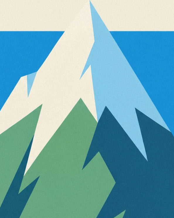 The angular peaks with cream and light blue faces above the green slopes