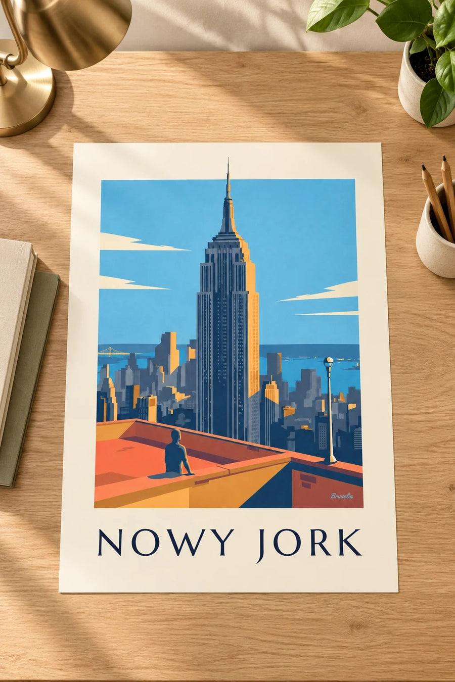 Plakat Empire State Building nad Manhattanem w Nowym Jorku: położony na stole