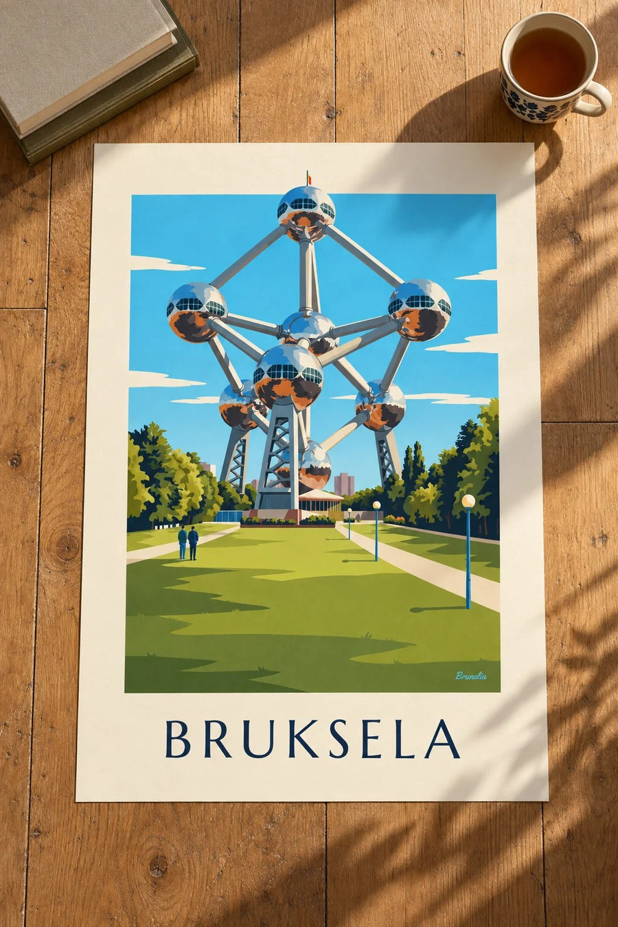 Plakat Atomium w Brukseli i trawniki parku: na stole
