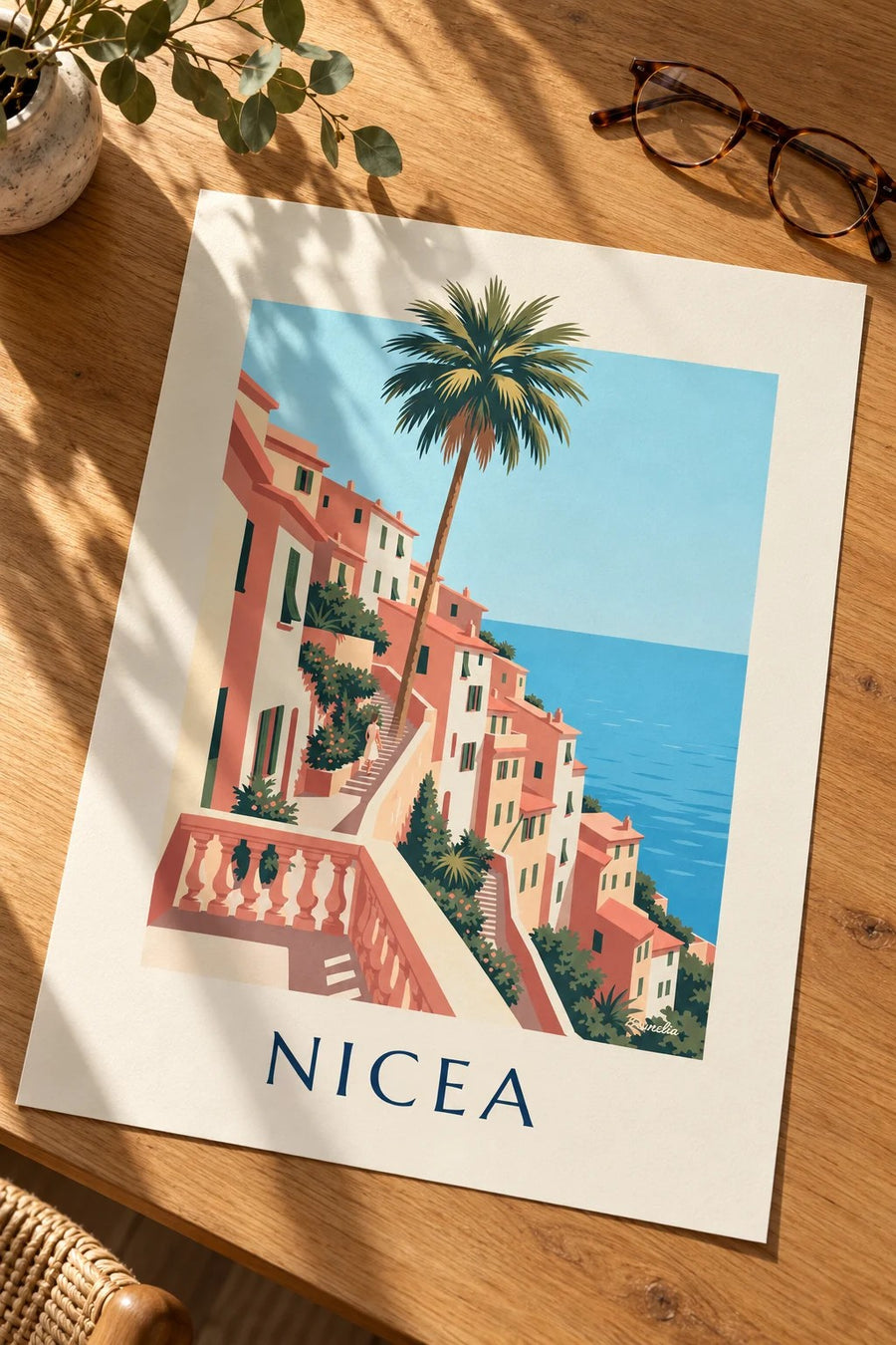 Plakat z ochrowymi domami i lazurowym morzem na wzgórzach Nicei: na stole