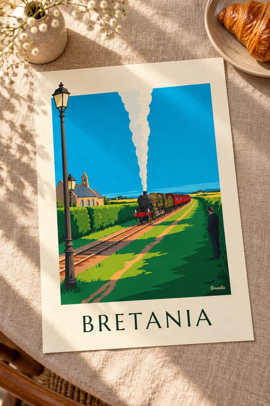Plakat lokomotywa parowa na bretońskiej wsi: na stole