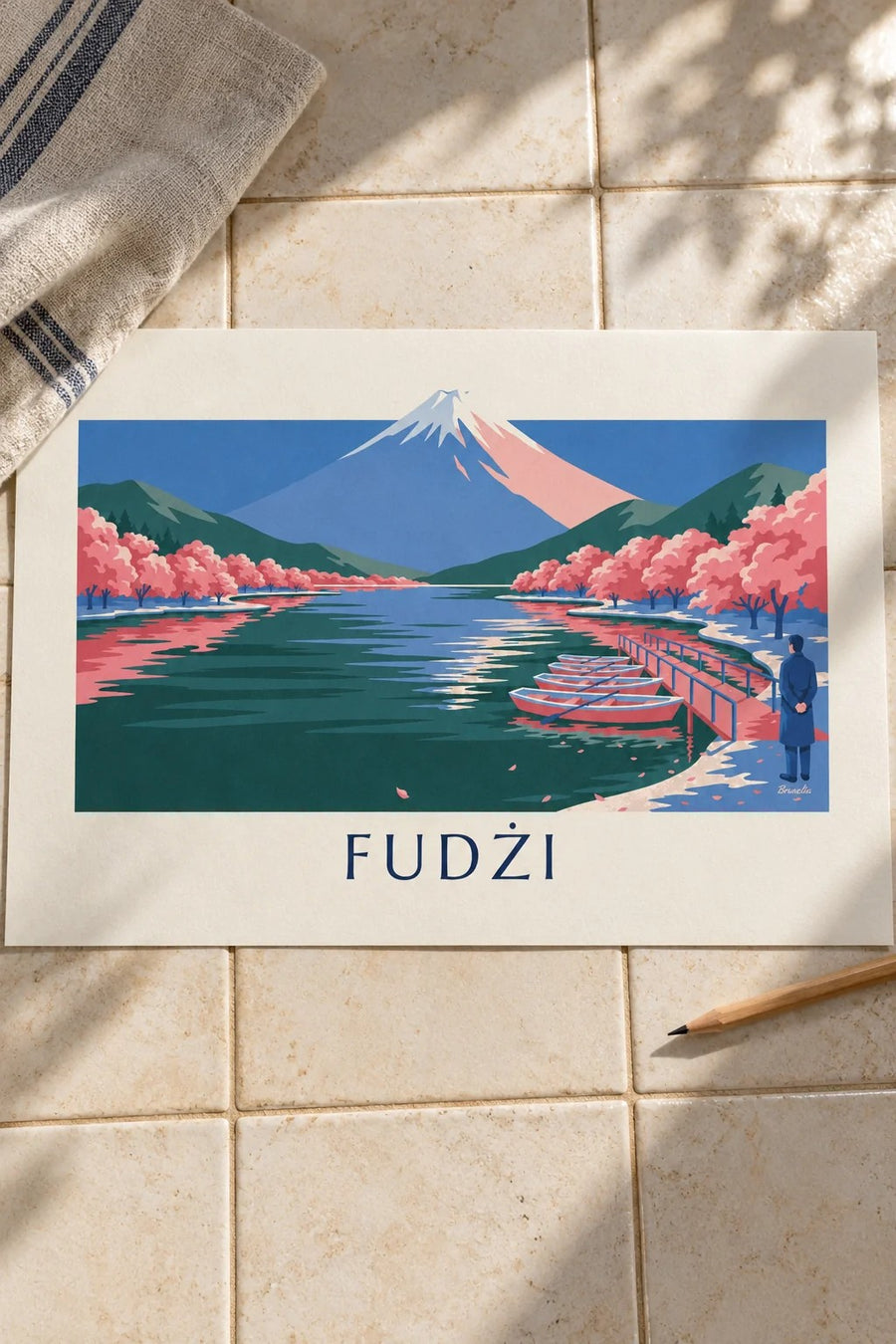 Plakat góra Fuji, kwitnące wiśnie i łódki przy pomoście: na stole
