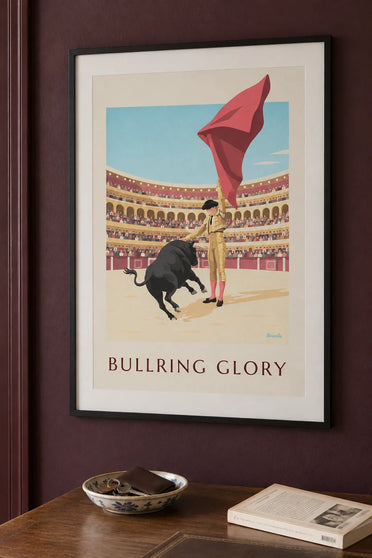 Poster of a matador and a black bull in a sunlit arena: framed on the wall