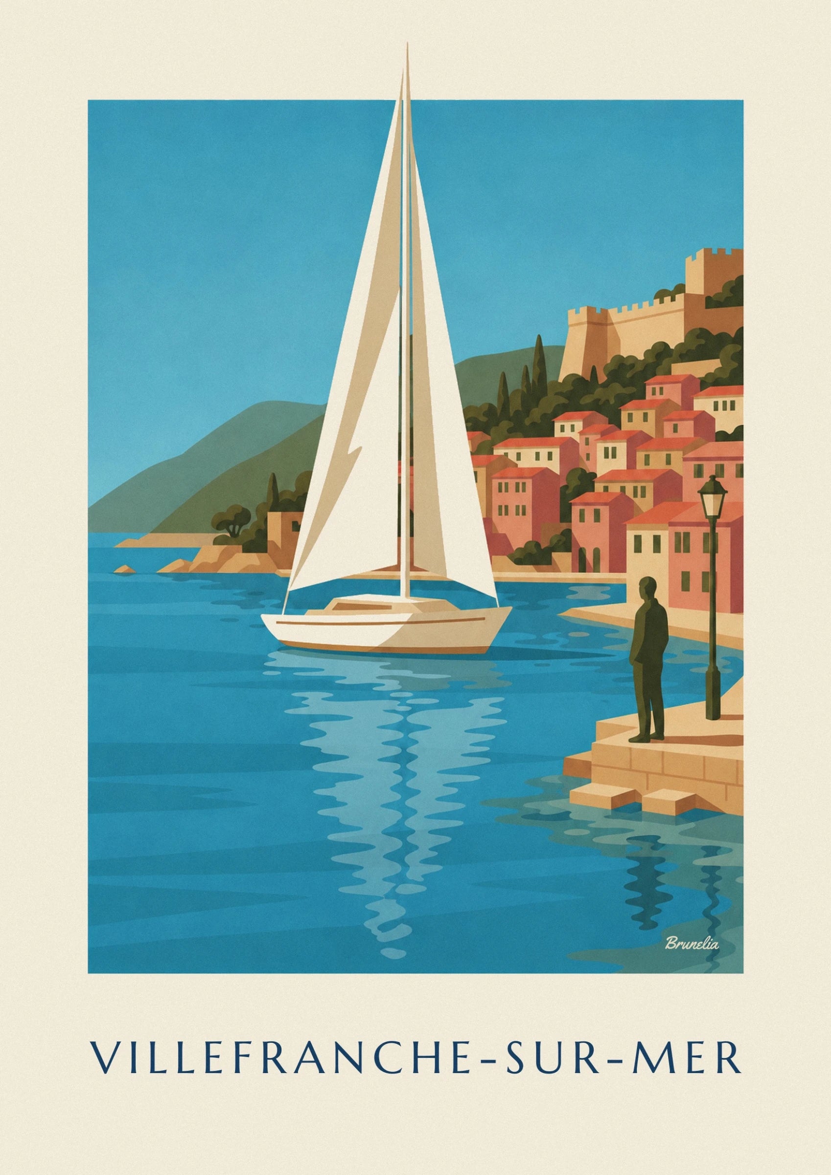 Le voilier aux voiles crème devant les façades colorées de Villefranche-sur-Mer