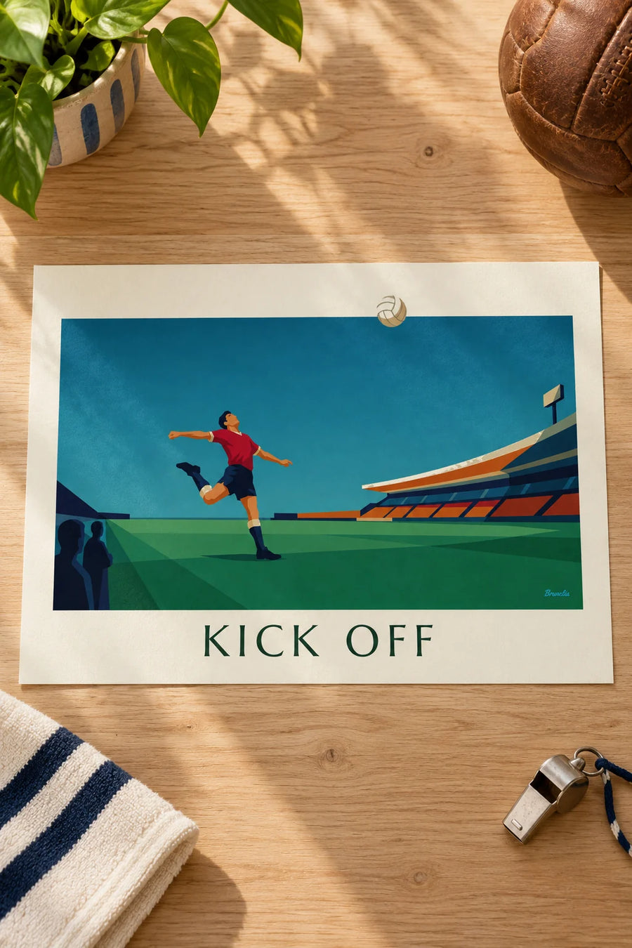 Affiche joueur de football frappant le ballon dans un stade : posée sur une table